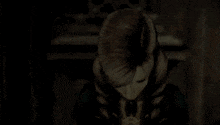 a close up of a woman 's face in a dark room
