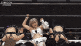 a woman in a wrestling ring with the word stardom on the bottom right