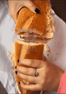 a woman is holding a sandwich with a sticker that says ' true love ' on it