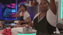 two women in a kitchen with netflix written on the bottom right