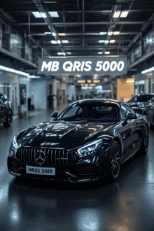 a black mercedes is parked under a sign that says mb qris 5000