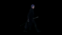 a man is walking with a sword in his hand