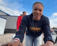 a woman wearing a blue indiana basketball sweatshirt smiles