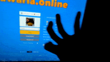 a person 's hand is visible in front of a screen that says ' online '