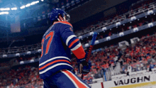 a hockey player with the number 17 on his jersey is holding a hockey stick