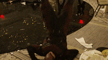 a man in a superhero costume is laying upside down on the floor