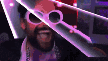 a man with a beard is wearing sunglasses and a purple tie