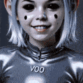 a girl with black eyes is wearing a shirt that says voo on it