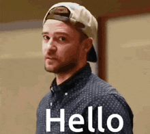 a man wearing a baseball cap and a shirt says hello