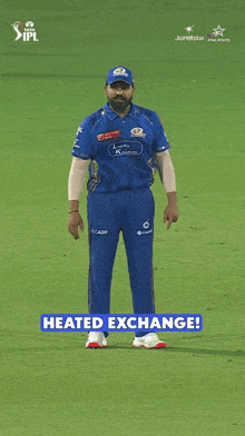 a man in a blue ipl jersey is standing on a field
