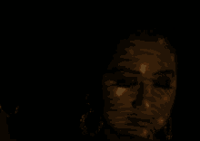 a close up of a woman 's face in a dark room
