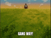 a man sits in a grassy field with the words gang way written below him