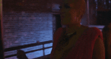 a blurry picture of a woman in a red shirt