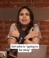 a girl is hugging herself in front of a microphone with the words girl who is " going to be okay " on the bottom