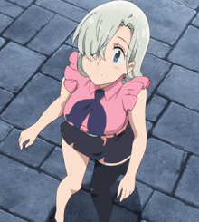 a girl in a pink shirt and black shorts is standing on a brick floor