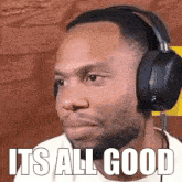 a man wearing headphones has the words it 's all good written on his face