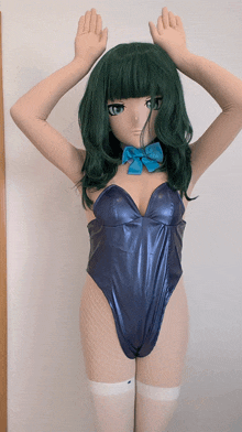 a woman with green hair is wearing a blue swimsuit