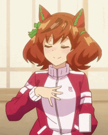 a girl in a red and white jacket has a circle on her chest