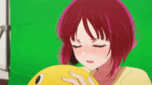 a girl with red hair is holding a yellow ball