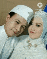 a man and a woman are posing for a picture .