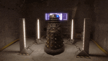 a robot with a blue light on its head is chained to a wall in a dark room