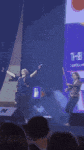 a man in a black shirt is standing in front of a stage