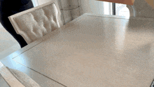 a dining room table with a white chair