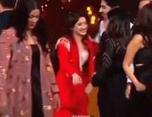 a group of women are standing next to each other in a room .
