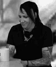 marilyn manson laughing covers face