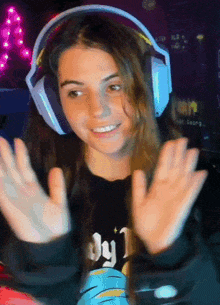 a girl wearing headphones and a black shirt that says ' by ' on it