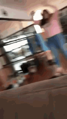 a blurry picture of a person standing on a couch
