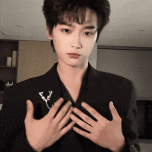 a man wearing a black jacket has his hands crossed
