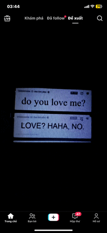 a phone screen shows a message that says do you love me love haha no