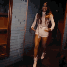 a woman in shorts and cowboy boots is dancing