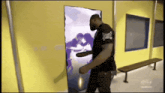 a man wearing a black everlast shirt is standing in front of a door
