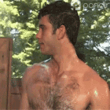 a man without a shirt is taking a bath outside .