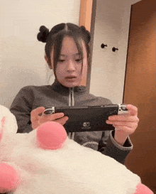 a young girl is playing a game on a nintendo switch
