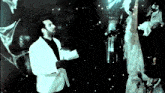 a man in a white suit stands in front of a ghost
