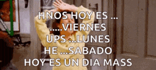a woman in a yellow sweater is standing in front of a door with her hands in the air .
