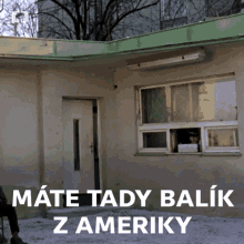 a man looking out of a window with the words mate tady balik z ameriky on the bottom