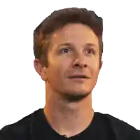 a close up of a man 's face with a black shirt on
