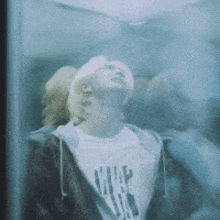 a man wearing a shirt that says ' nirvana ' on it