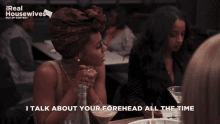 a woman sitting at a table with the words i talk about your forehead all the time on the bottom