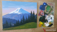 a painting of a mountain and trees next to a palette that says made in animatica