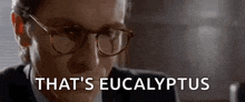 a close up of a man wearing glasses and a suit .