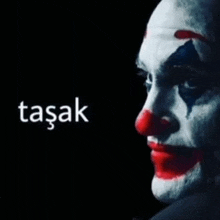 a close up of a clown 's face with the word tasak on the bottom right