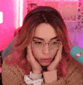 a girl with pink hair wearing glasses and a headband with a bottle of soda sticker on it