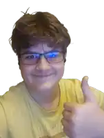 a young boy wearing glasses and a yellow shirt is giving a thumbs up