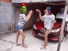 a couple of people dancing in front of a red car