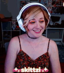 a woman wearing headphones with skittzi written on the bottom right